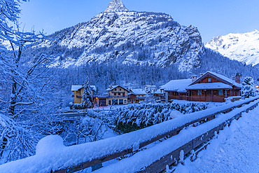 View of chalets and snow covered mountains in Courmayeur before dawn during winter, Courmayeur, Aosta Valley, Italy, Europe