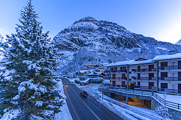 View of chalets and snow covered mountains in Courmayeur before dawn during winter, Courmayeur, Aosta Valley, Italy, Europe