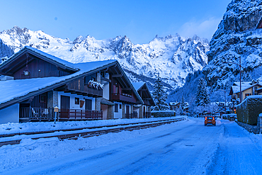 View of chalets and snow covered mountains in Courmayeur before dawn during winter, Courmayeur, Aosta Valley, Italy, Europe