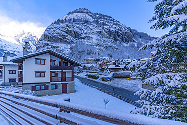 View of hotels, chalets and snow covered mountains in Courmayeur at sunrise during winter, Courmayeur, Aosta Valley, Italy, Europe