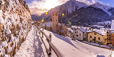 View of snow covered mountains, rooftops and Church of Saint Pantalon in Courmayeur during winter, Courmayeur, Aosta Valley, Italy, Europe