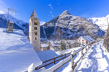 View of snow covered mountains, rooftops and Church of Saint Pantalon in Courmayeur during winter, Courmayeur, Aosta Valley, Italy, Europe