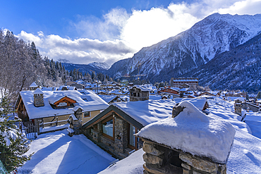 View of snow covered mountains and rooftops in Courmayeur during winter, Courmayeur, Aosta Valley, Italy, Europe