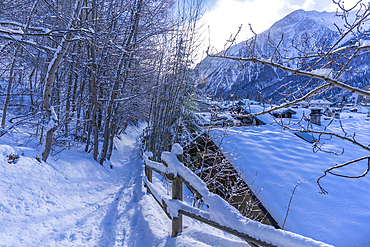 View of snow covered mountains and rooftops in Courmayeur during winter, Courmayeur, Aosta Valley, Italy, Europe