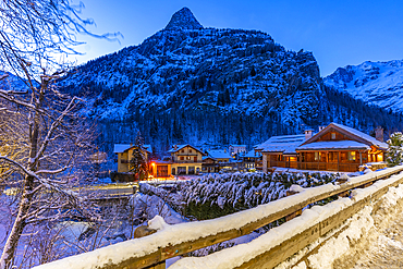 View of chalets and snow covered mountains in Courmayeur at dusk during winter, Courmayeur, Aosta Valley, Italy, Europe