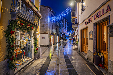 View of shops in town centre on Via Roma in Courmayeur during winter, Courmayeur, Aosta Valley, Italy, Europe