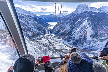 View of snow covered Aosta Valley and mountains from Skyway Monte Bianco cable car in winter, Courmayeur, Aosta Valley, Italy, Europe