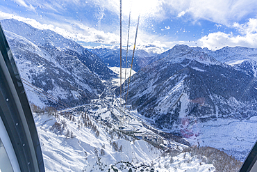 View of snow covered Aosta Valley and mountains from Skyway Monte Bianco cable car in winter, Courmayeur, Aosta Valley, Italy, Europe