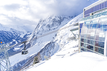 View of snow covered Aosta Valley, mountains and Skyway Monte Bianco cable car in winter, Courmayeur, Aosta Valley, Italy, Europe