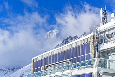 View of snow covered mountain peaks and Skyway Monte Bianco cable car station in winter, Courmayeur, Aosta Valley, Italy, Europe