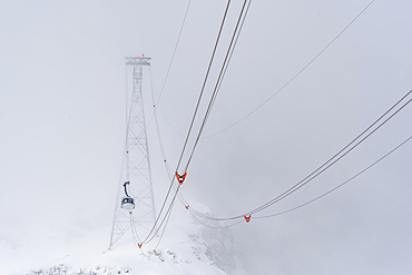 View of snow covered Aosta Valley, mountains and Skyway Monte Bianco cable car in winter, Courmayeur, Aosta Valley, Italy, Europe