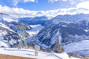 View of snow covered Aosta Valley, mountains and Skyway Monte Bianco cable car in winter, Courmayeur, Aosta Valley, Italy, Europe