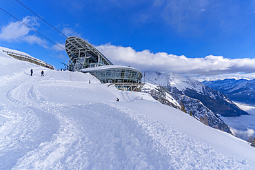 View of snow covered Aosta Valley, mountains and Skyway Monte Bianco cable car station in winter, Courmayeur, Aosta Valley, Italy, Europe