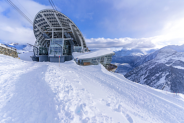 View of snow covered Aosta Valley, mountains and Skyway Monte Bianco cable car station in winter, Courmayeur, Aosta Valley, Italy, Europe