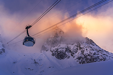 View of snow covered Aosta Valley, mountains and Skyway Monte Bianco cable car in winter, Courmayeur, Aosta Valley, Italy, Europe