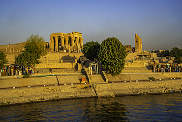 View of Kom Ombo Temple on the Nile river from cruise boat at sunset, Aswan, Nubia, Egypt, North Africa, Africa