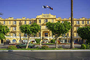 View of the Winter Palace Hotel on the corniche in Luxor on a sunny day, Luxor, Egypt, Africa