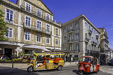 View of cafe and restaurant with Tuk Tuks in Lisbon city centre, Lisbon, Portugal, Europe