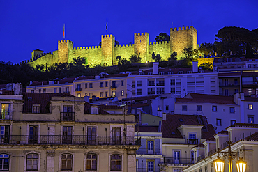 View of hilltop Castelo de São Jorge, (Lisbon Castle) illuminated at dusk, Lisbon, Portugal, Europe