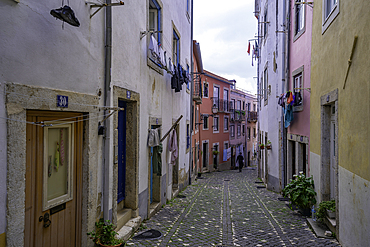 View of narrow cobbled street close to Lisbon Castle, Alfama District, Lisbon, Portugal, Europe
