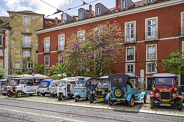 View of Tuk Tuks and colourful architecture in Alfama, Alfama District, Lisbon, Portugal, Europe