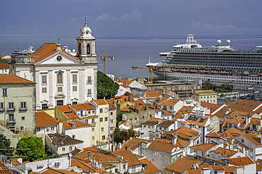 View of cruise ship in port and terrakotta rooftops in Alfama, Alfama District, Lisbon, Portugal, Europe