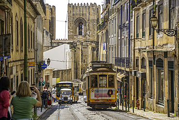 View of vintage tram and Lisbon Cathedral in Alfama, Alfama District, Lisbon, Portugal, Europe