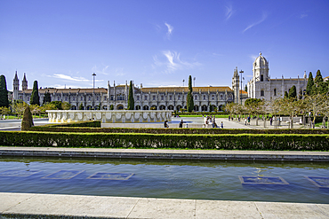 View of Jerónimos Monastery (Monastery of the Hieronymites) from Empire Square Garden on a sunny day, Lisbon, Portugal, Europe