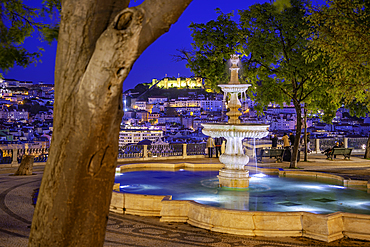 View of Lisbon and fountain in Miradouro de São Pedro de Alcântara at dusk, Lisbon, Portugal, Europe