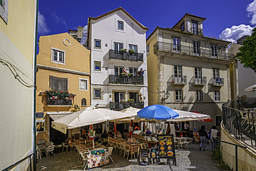 View of colourful buildings and cafe in the Alfama District on a sunny day, Lisbon, Portugal, Europe
