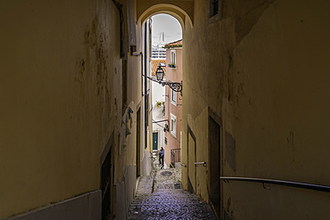 View of narrow street leading to cruise ship in port in the Alfama District, Lisbon, Portugal, Europe