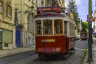 View of vintage red tram on a sunny day in the Alfama District, Lisbon, Portugal, Europe