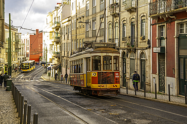 View of vintage tram and colourful buildings in the Alfama District on a sunny day, Lisbon, Portugal, Europe