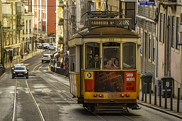 View of vintage tram and colourful buildings in the Alfama District on a sunny day, Lisbon, Portugal, Europe