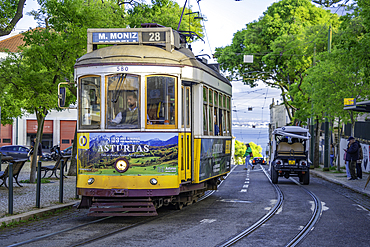 View of vintage tram and colourful buildings in the Alfama District on a sunny day, Lisbon, Portugal, Europe
