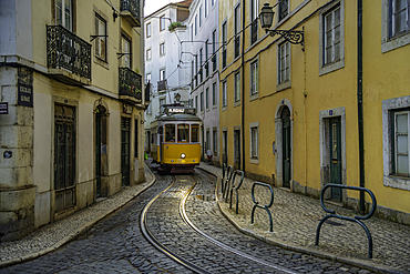 View of vintage tram and colourful buildings in the Alfama District on a sunny day, Lisbon, Portugal, Europe