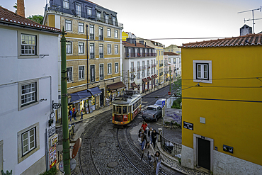 View of vintage tram and colourful buildings in the Alfama District on a sunny day, Lisbon, Portugal, Europe