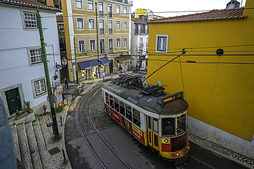 View of vintage tram and colourful buildings in the Alfama District on a sunny day, Lisbon, Portugal, Europe