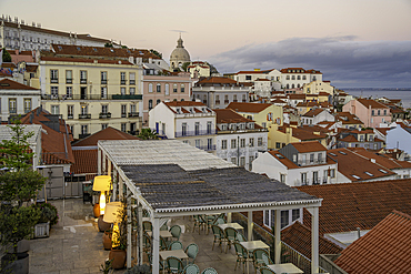 View of colourful buildings and red rooftops at sunset in the Alfama District, Lisbon, Portugal, Europe