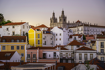 View of colourful buildings and red rooftops at sunset in the Alfama District, Lisbon, Portugal, Europe