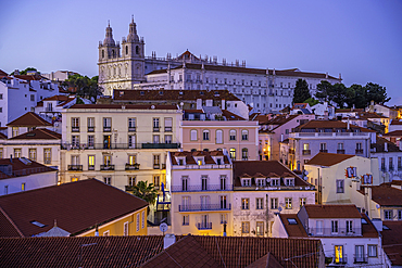 View of colourful buildings and red rooftops at dusk in the Alfama District, Lisbon, Portugal, Europe
