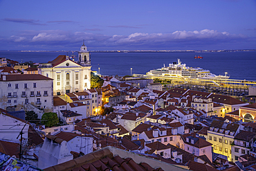 View of colourful buildings and red rooftops at dusk in the Alfama District, Lisbon, Portugal, Europe