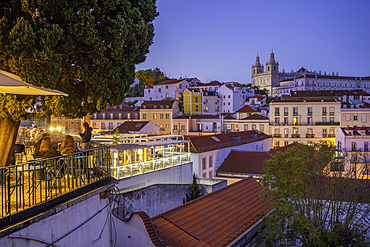 View of colourful buildings and red rooftops at dusk in the Alfama District, Lisbon, Portugal, Europe