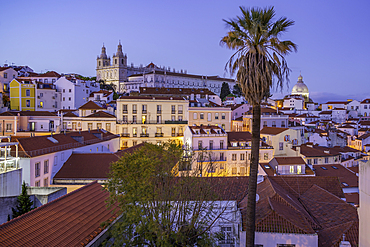 View of colourful buildings and red rooftops at dusk in the Alfama District, Lisbon, Portugal, Europe