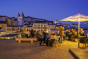 View of colourful buildings and red rooftops at dusk in the Alfama District, Lisbon, Portugal, Europe