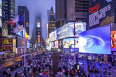 View of neon lights in Times Square at dusk, New York City, United States of America, North America