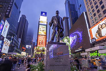 View of neon lights in Times Square at dusk, New York City, United States of America, North America