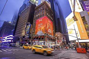 View of neon lights in Times Square at dusk, New York City, United States of America, North America