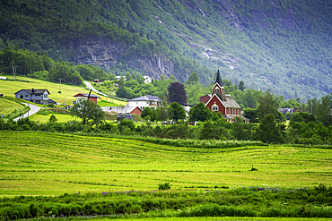 View of Olden New Church in Olden village and mountains in Nordfjorden during summer, Norway, Scandinavia, Europe