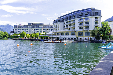 View of the Grand Hotel on Lake Zell from Zell am See and mountainous backdrop on a sunny day, Zell am See, Salzburg, Austria, Europe